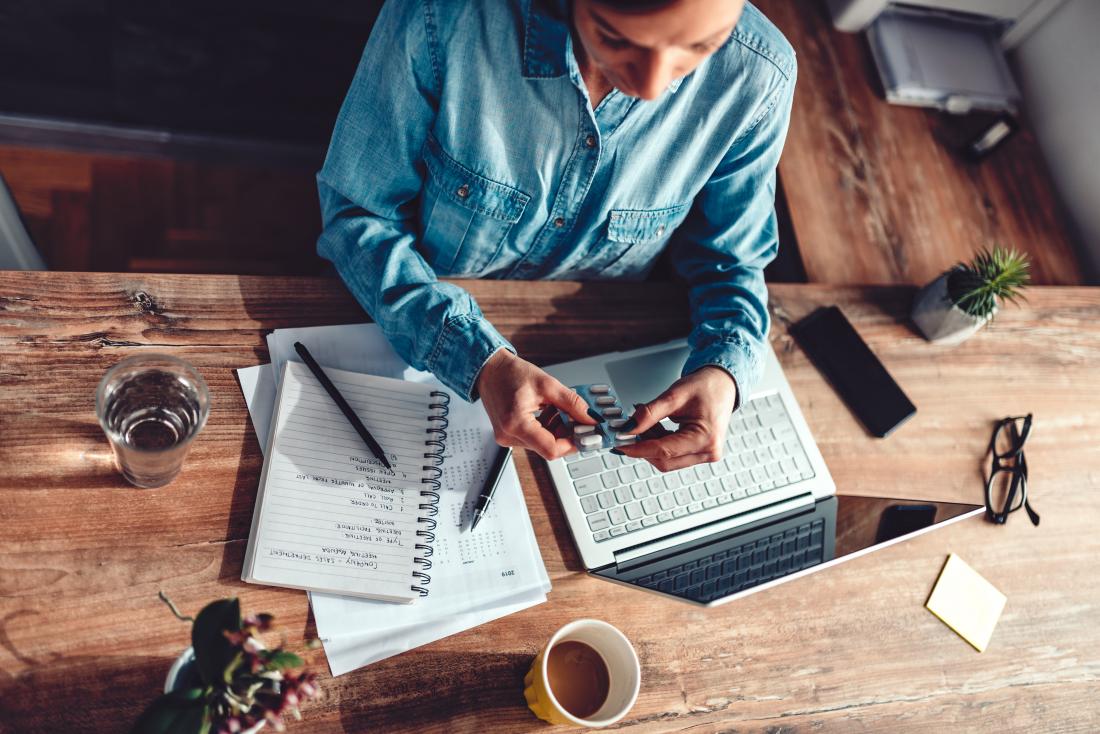 a woman taking nootropics at her desk.